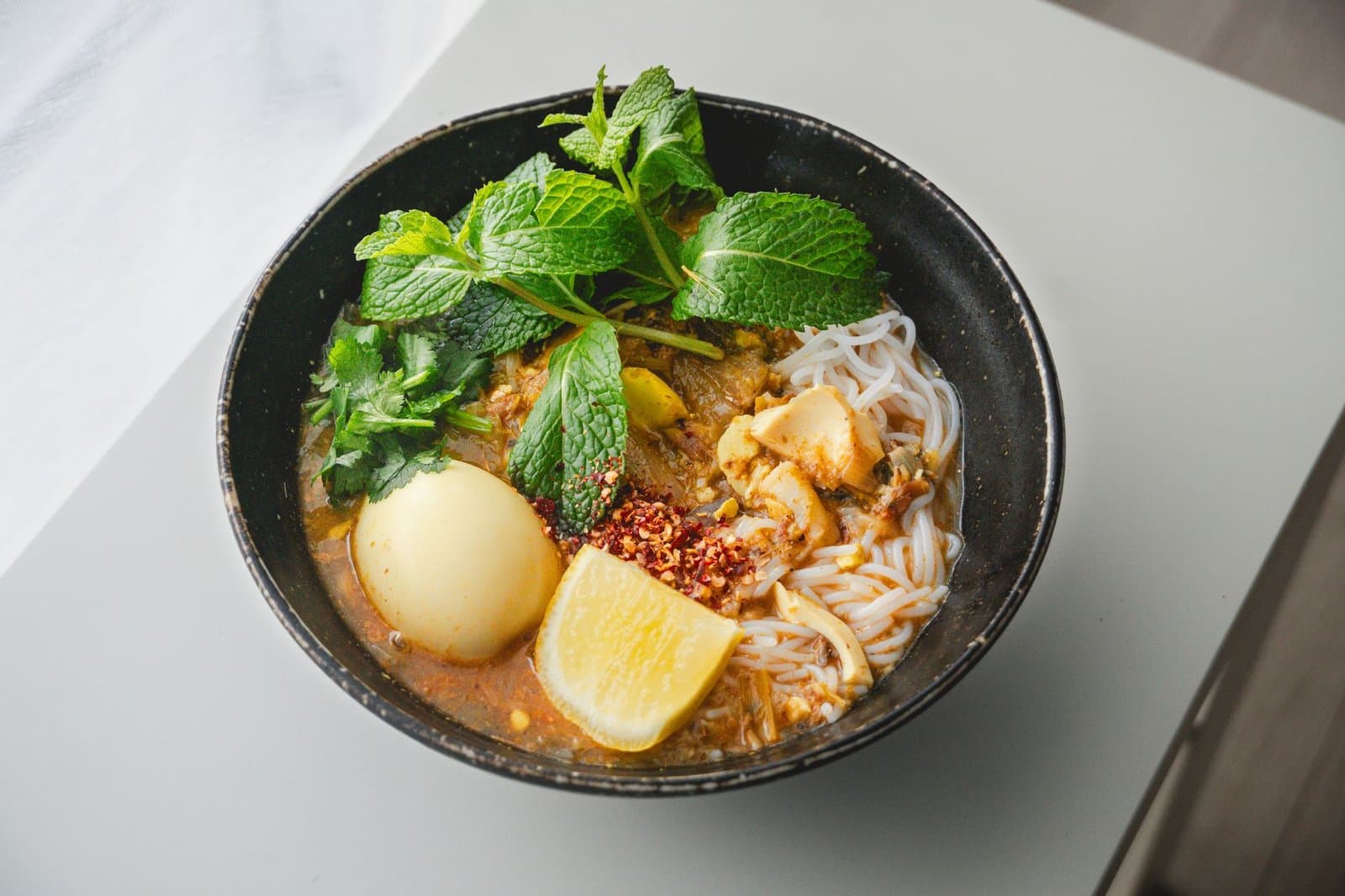 Bowl of Singapore laksa with noodles and broth